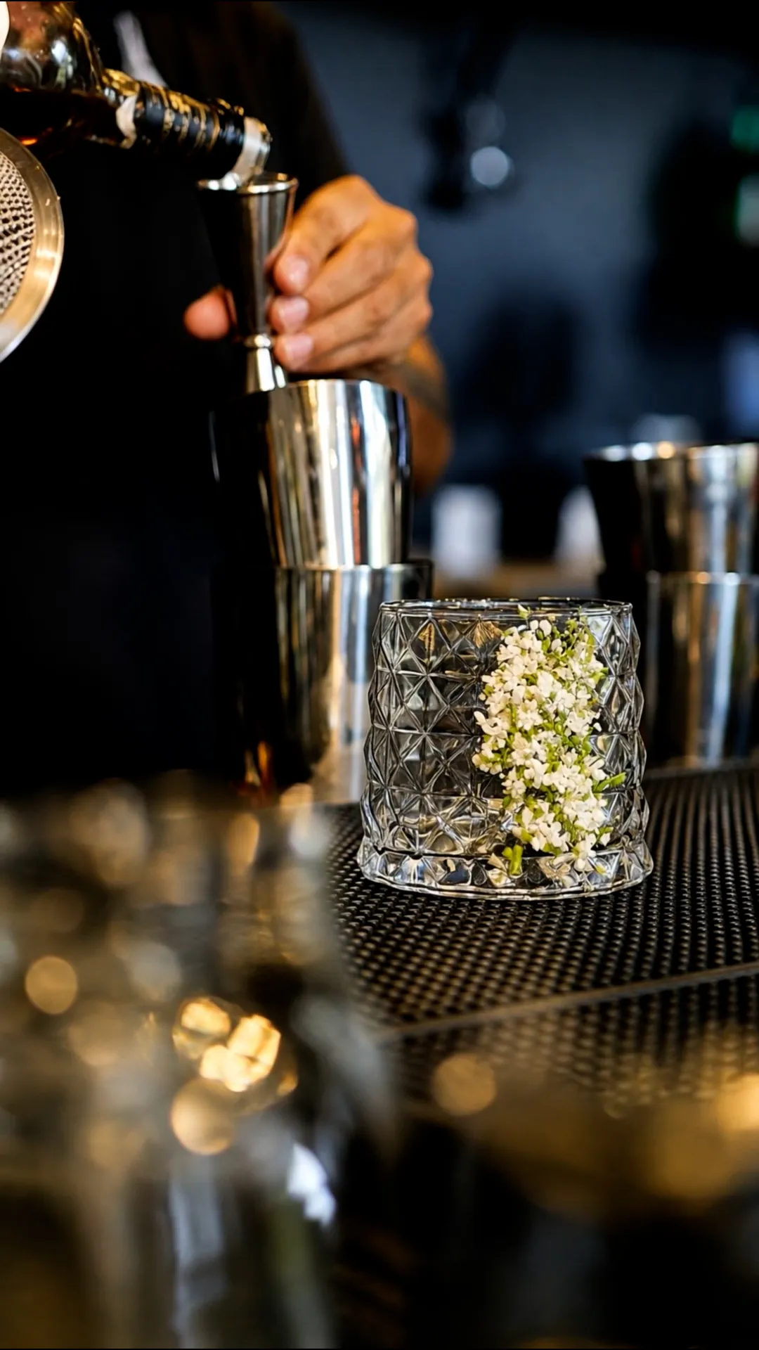 Bartender pouring spirits at the La French Riviera bar